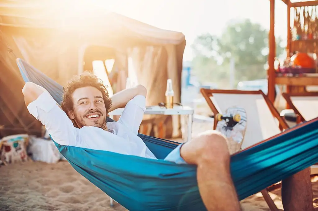 A guy resting on hammock near beach